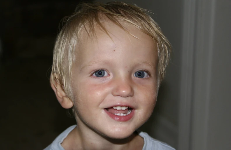 a child is smiling in front of the camera