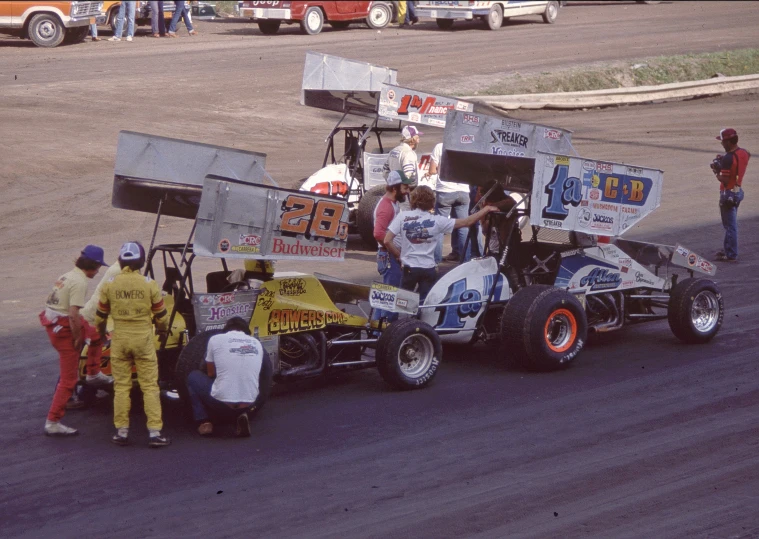 a racing car being loaded by mechanics on top of it