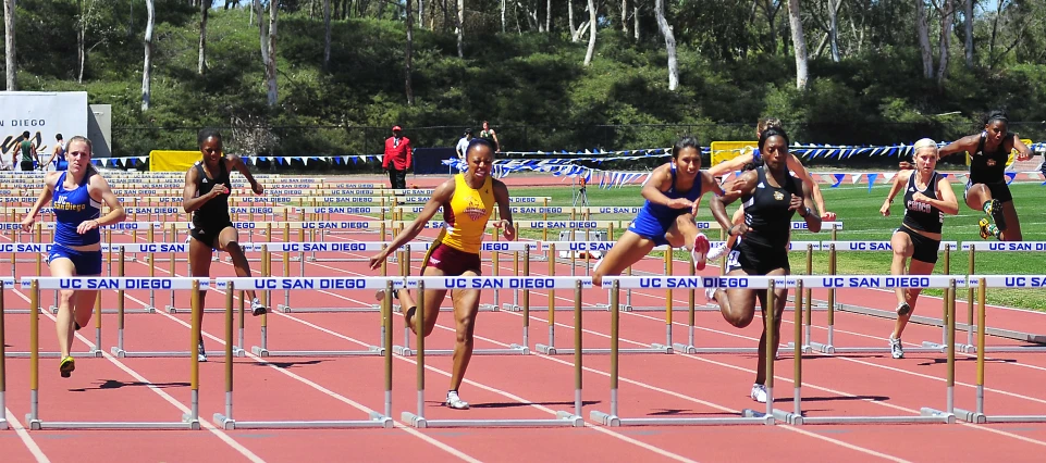 an athletics field with several women running across it