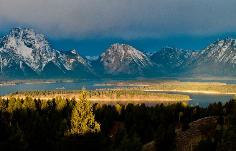 a scenic view of trees and water and mountains