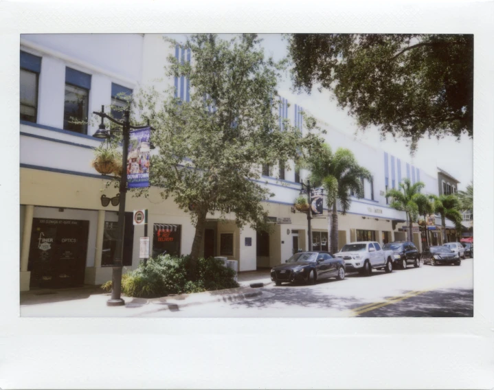 cars parked at the curb of a very narrow sidewalk