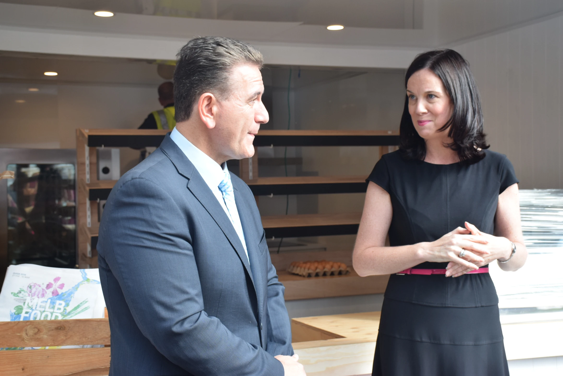 a woman standing next to a man in a room