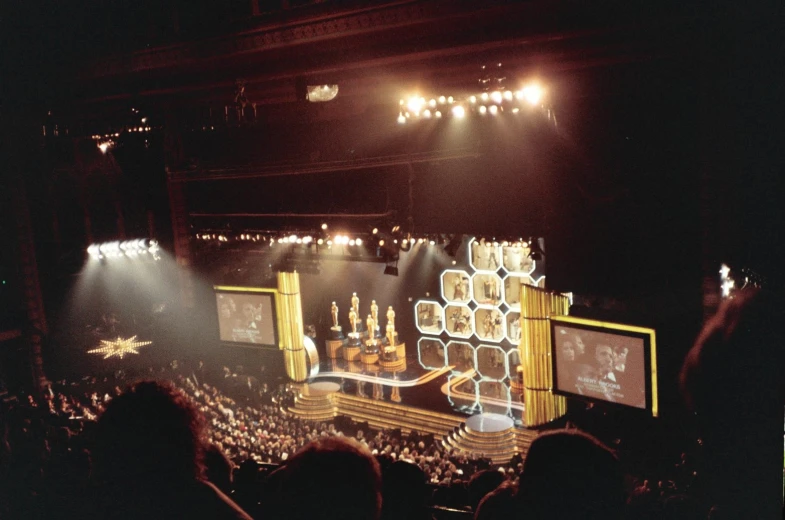 the crowd is in front of the stage with several lights on