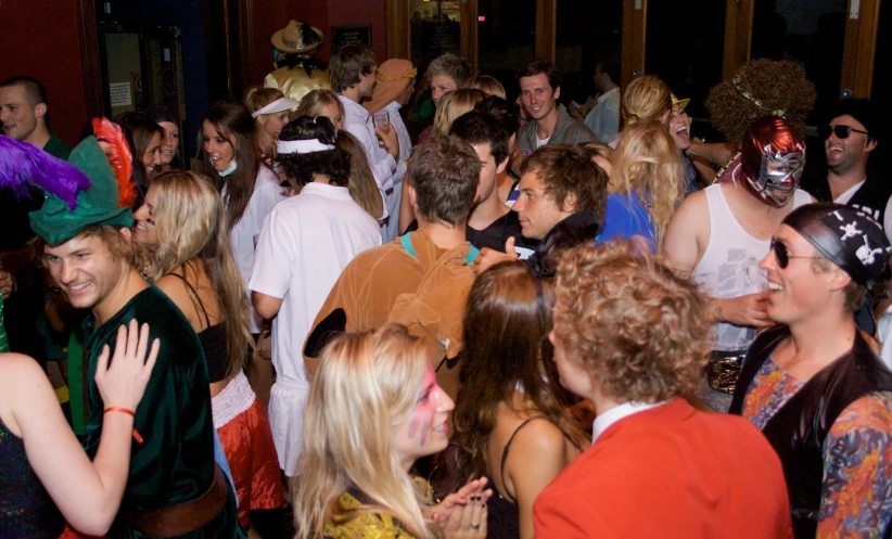 many people are smiling at a party