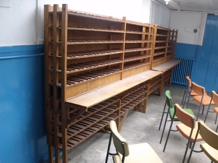 there are rows of wooden shelves and tables next to each other