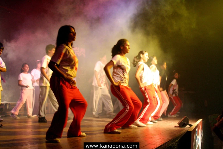 a group of people on a stage, dancing