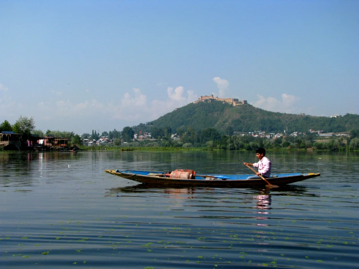 a person on a small boat in the water