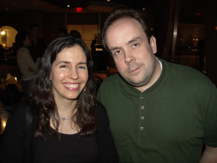 a man and woman are smiling while posing for a po