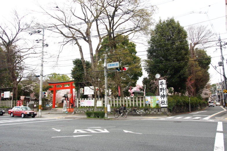 a city street intersection with cars, buses and signs on it