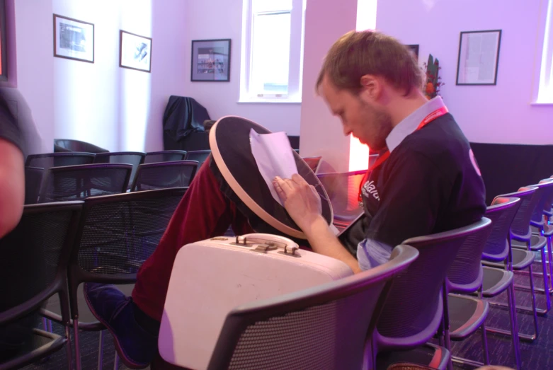 a man that is sitting down with a hat