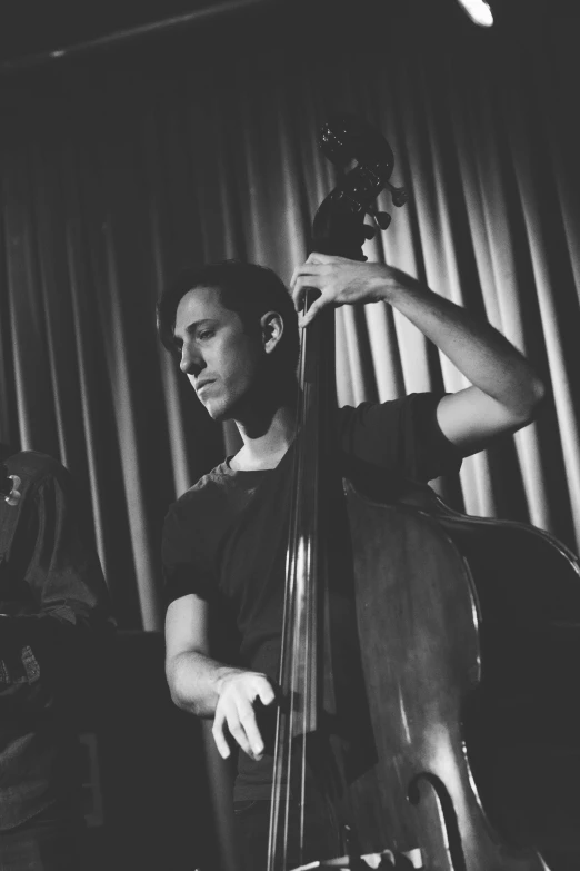 a man holding a bass next to another bass