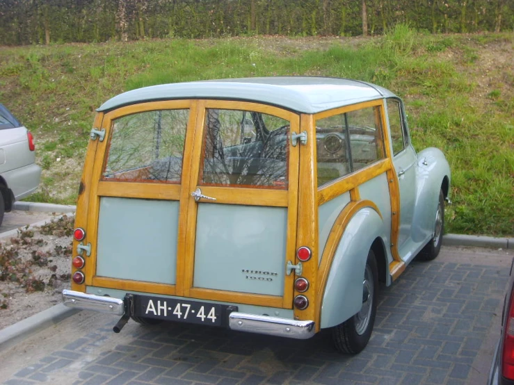 a small car with a wooden panelled design parked
