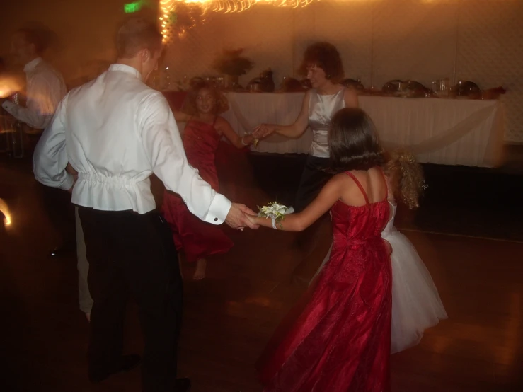 two people dancing while another person looks on