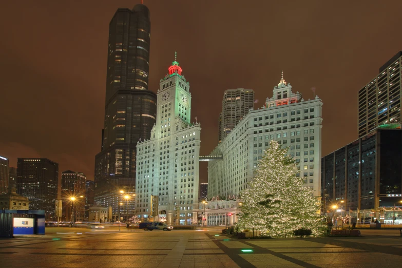 the christmas tree is surrounded by buildings along a street