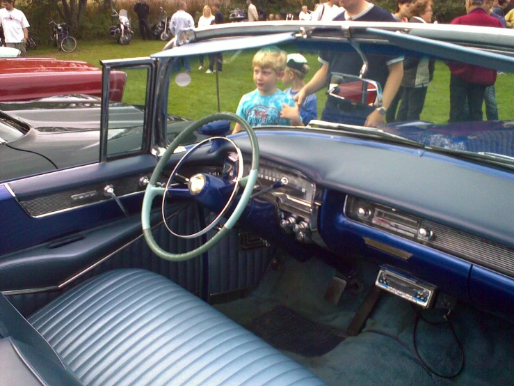 a  is sitting in a classic car