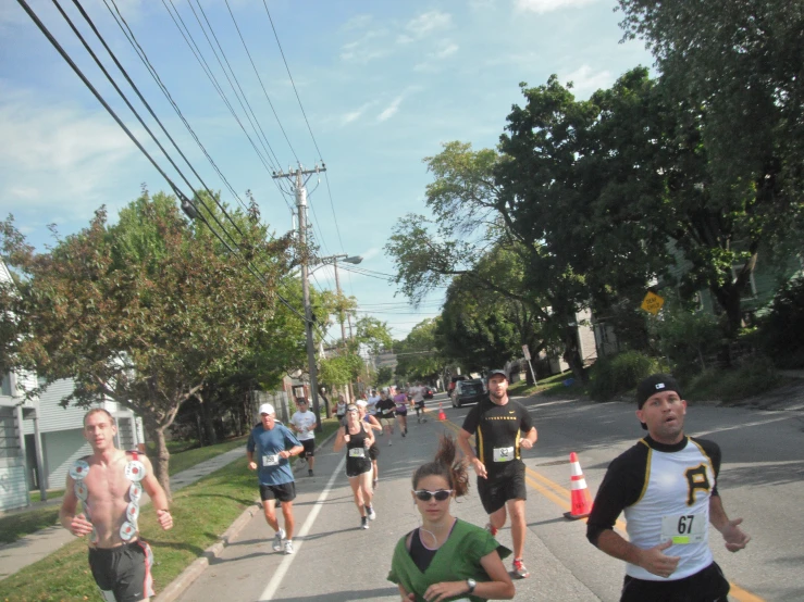 a bunch of runners are going down the road