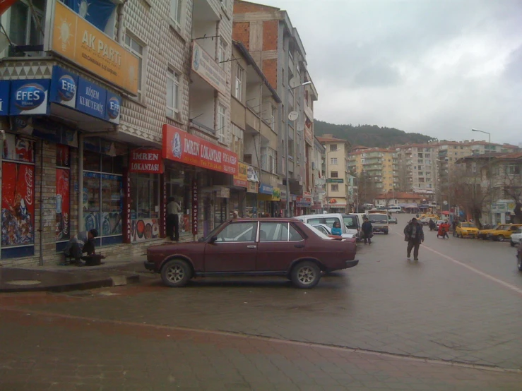 an old time car sitting on the side of a street