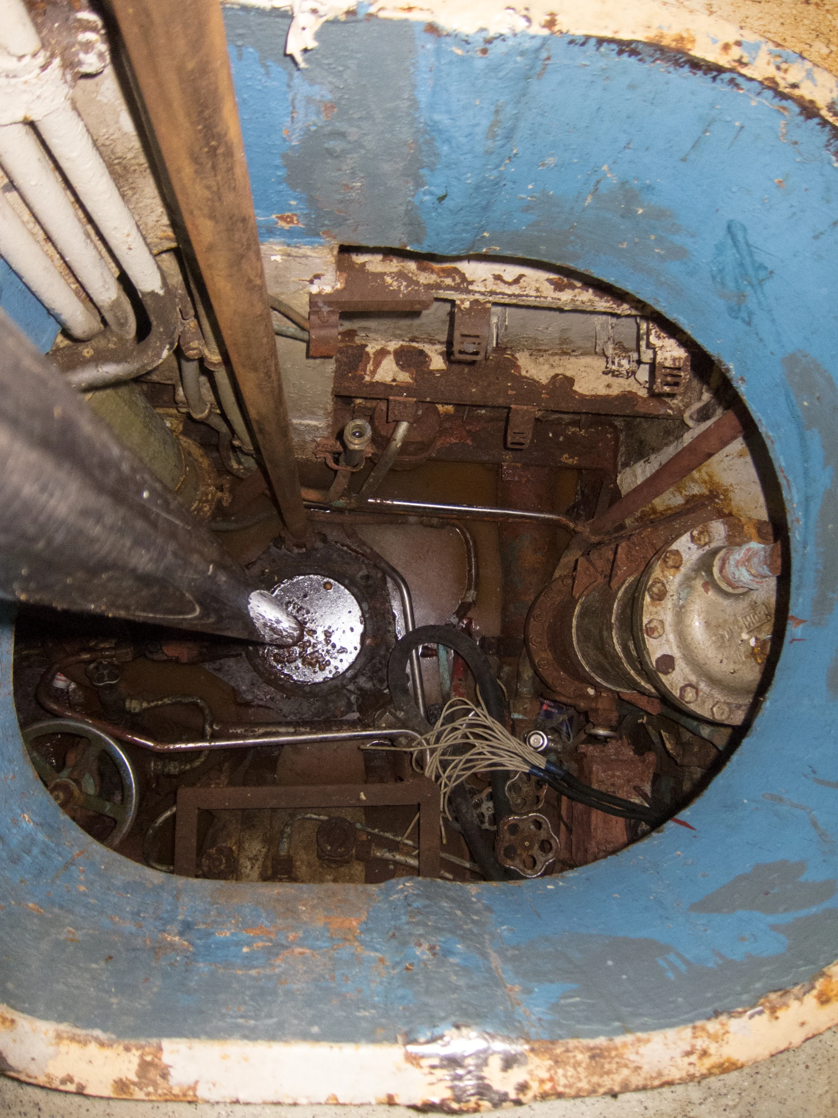 an overhead view of a broken toilet in an industrial bathroom