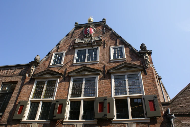 a clock on the top of an old brick building