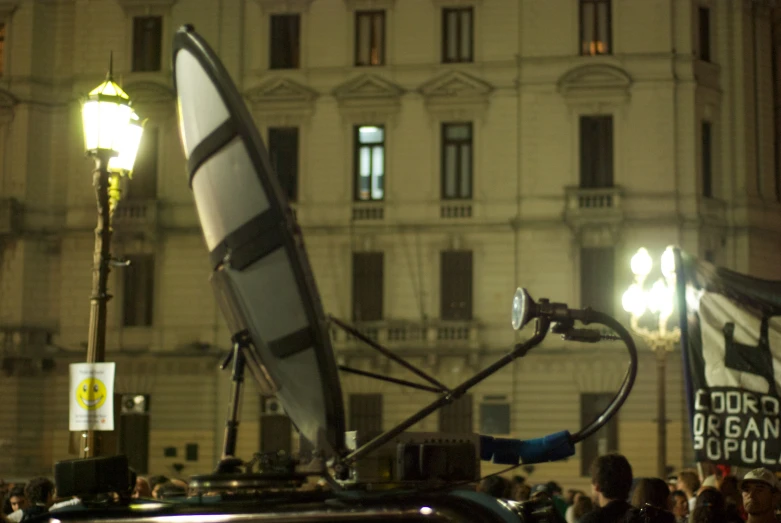 some light poles and lights and people at night