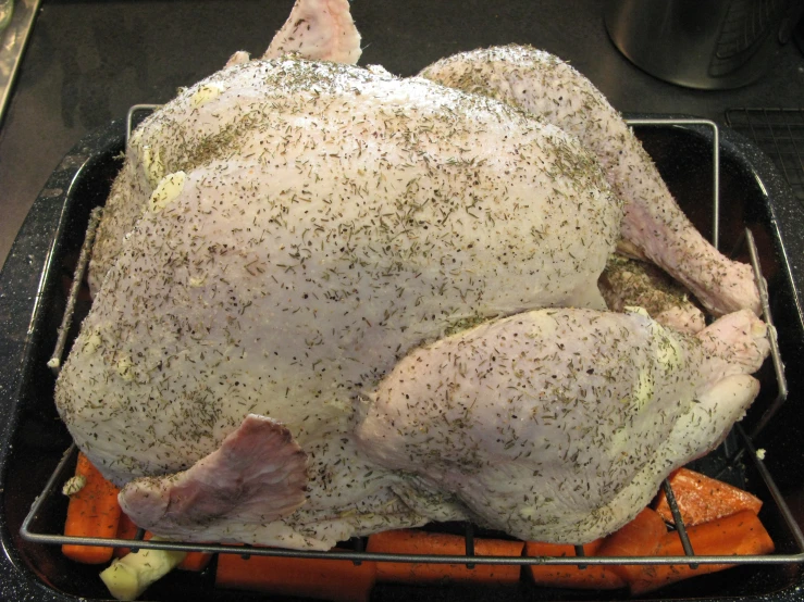 a big chicken is sitting on a pan