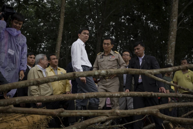 people in uniforms and some holding up sticks