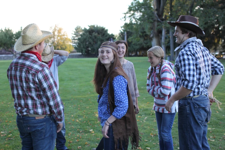 a group of people standing in the grass