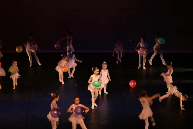 a group of dancers in pink leo bear costumes