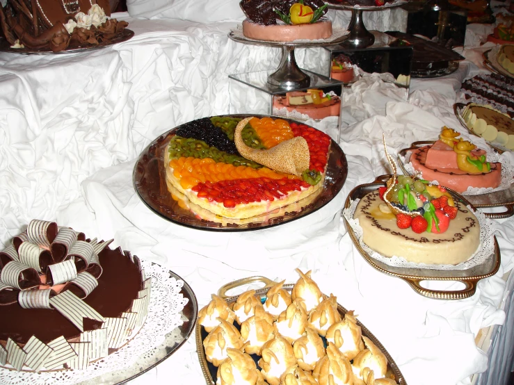cakes and desserts sitting on top of a table