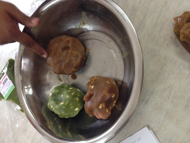 an empty metal bowl filled with raw food