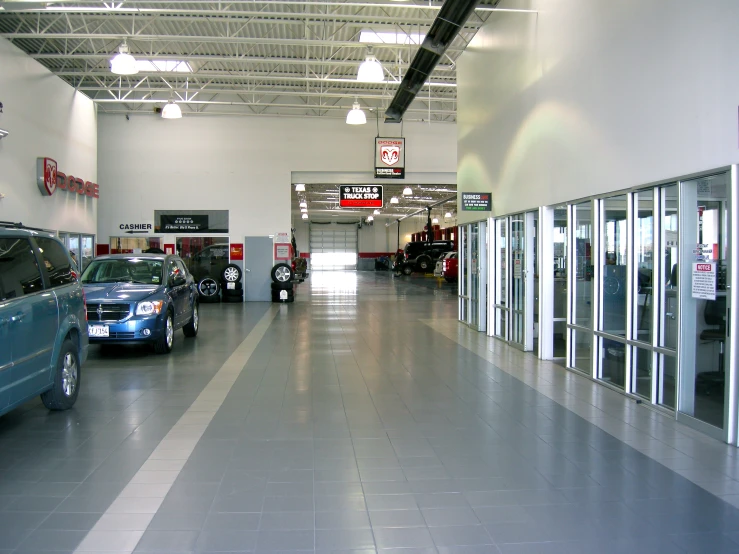 several cars are in a line at a car dealership