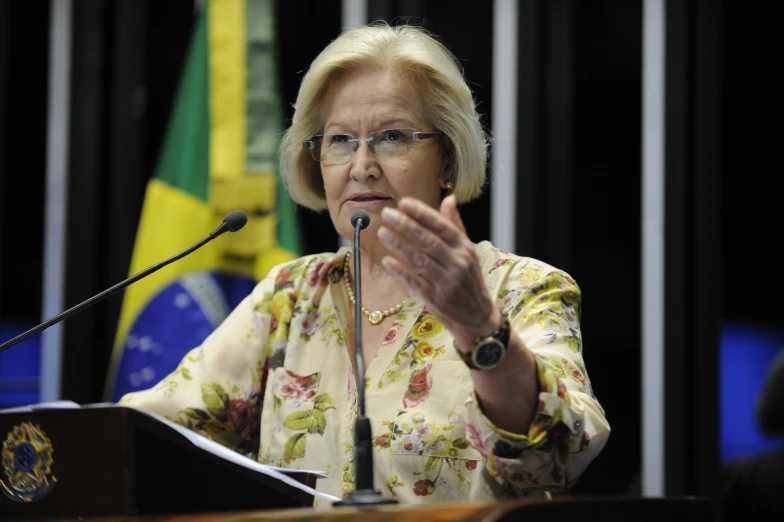 a woman standing at a podium giving a speech