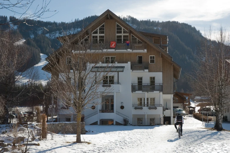 a snow covered hill behind a white building