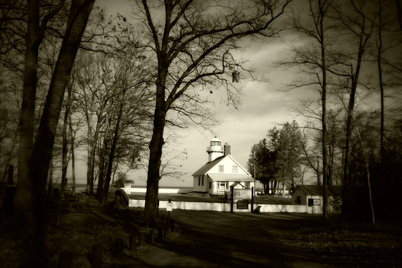 an old country house and church by some trees