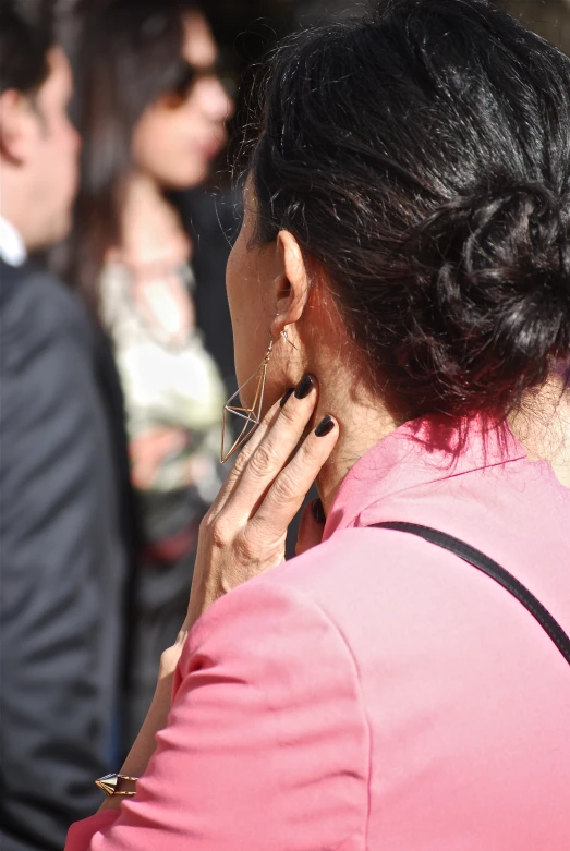 the back of a woman talking on a cell phone