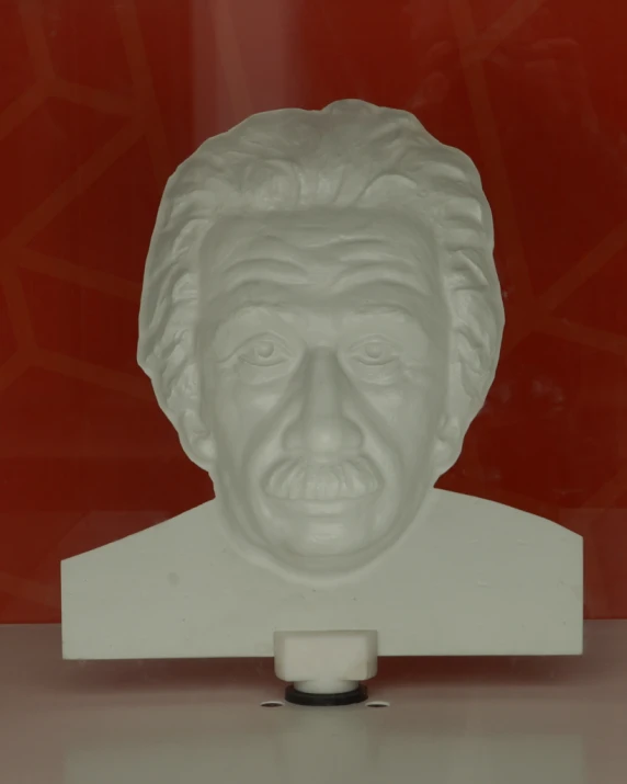 the bust of a man with a red background is made out of glass