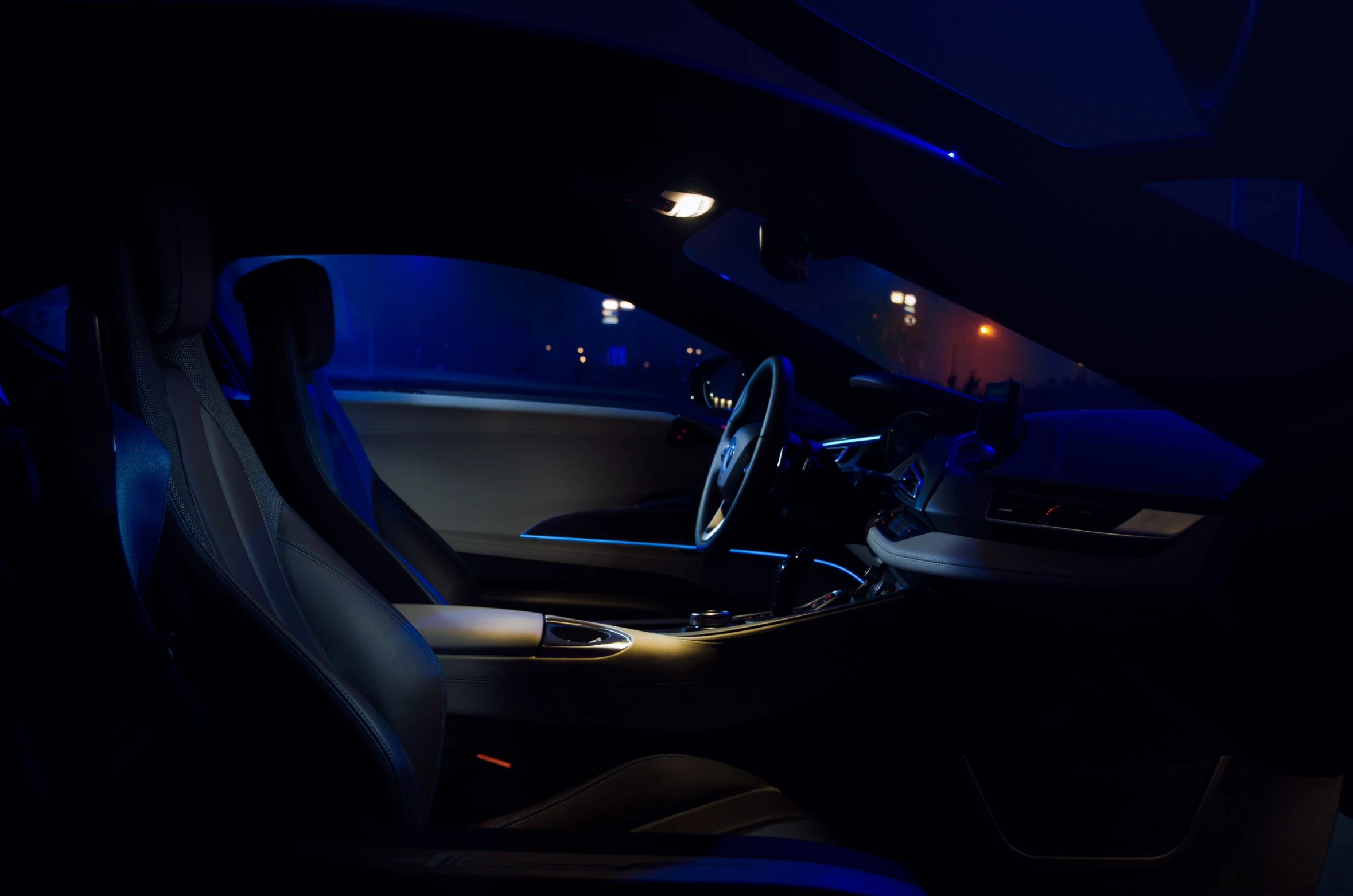 the interior of a modern looking car at night