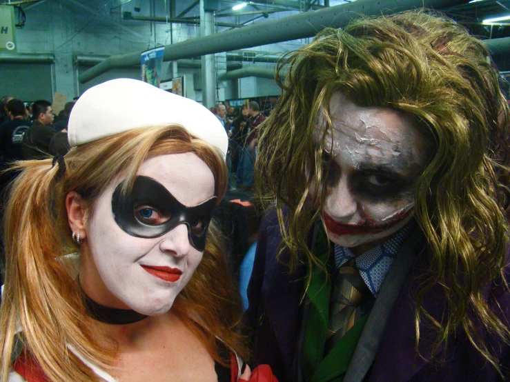 two people dressed up as jokers posing for a po