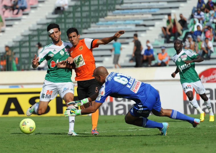 soccer players during the day, one man in orange and the other in blue