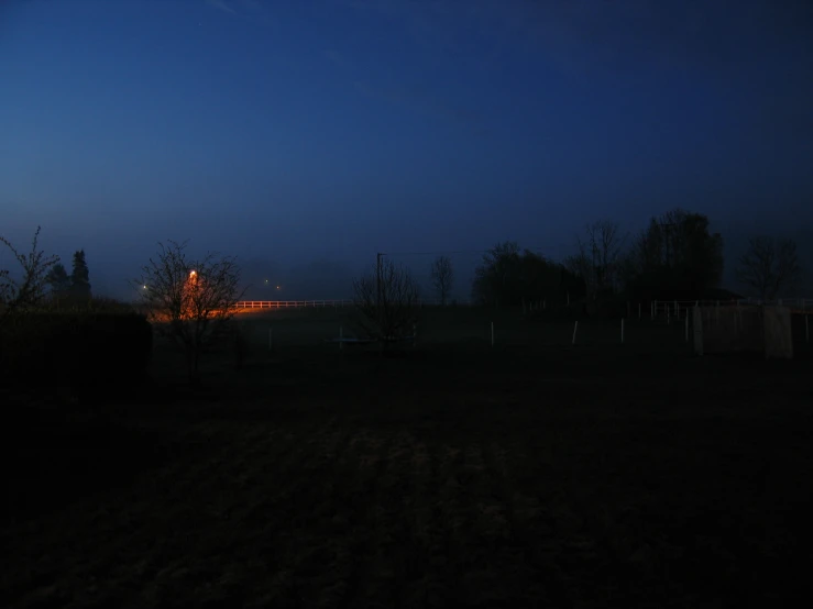 a red lighted bench in a dark field