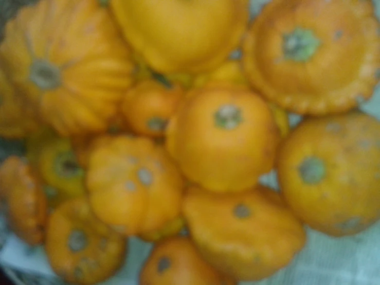 there are many orange pumpkins piled on top of each other