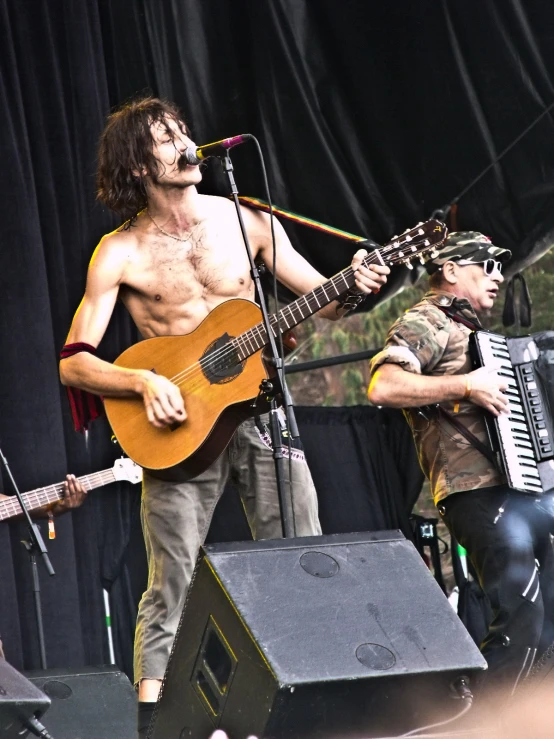 the man with the guitar is performing on the stage