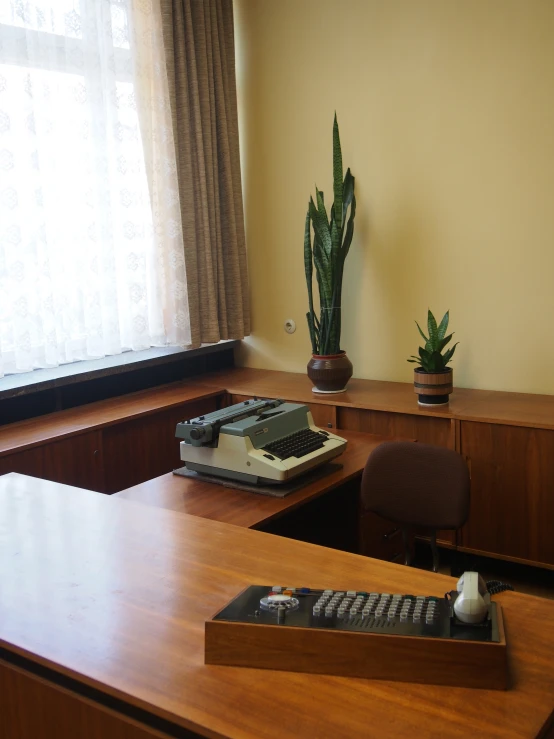 a desk with a typewriter on top of it