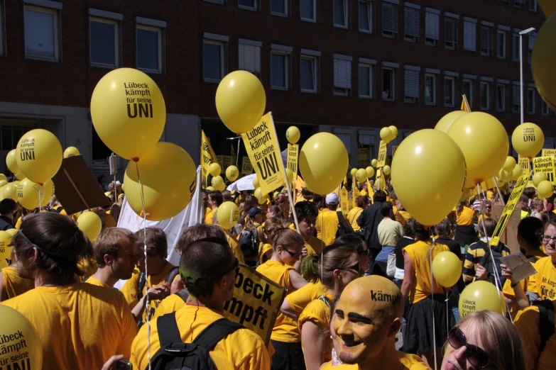 large group of yellow balloons and yellow people