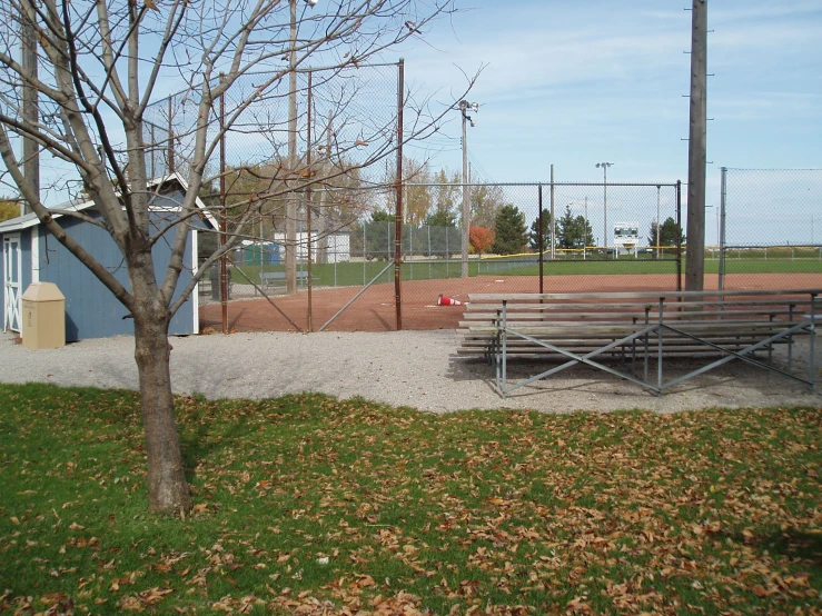 some benches are out in the grass and is empty