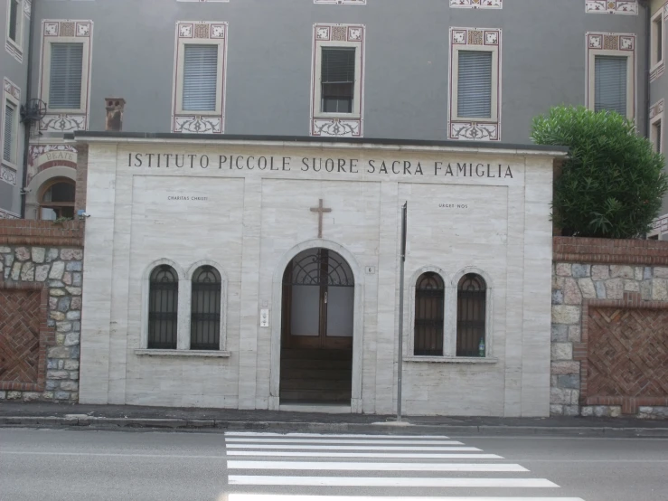 a big church next to a small brick wall