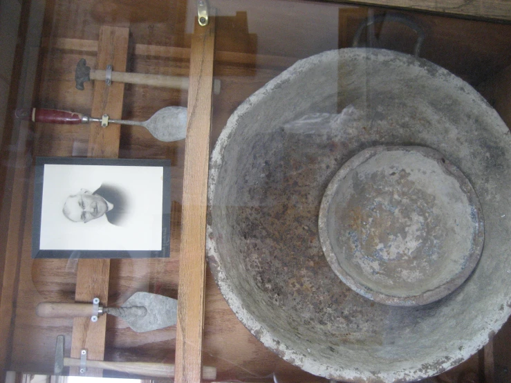 a stone bowl on display in a glass case
