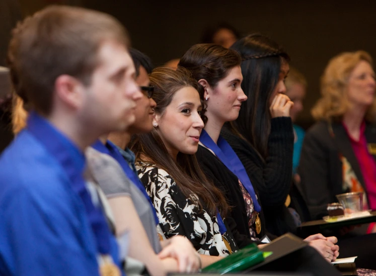 some people are sitting down in rows for a conference