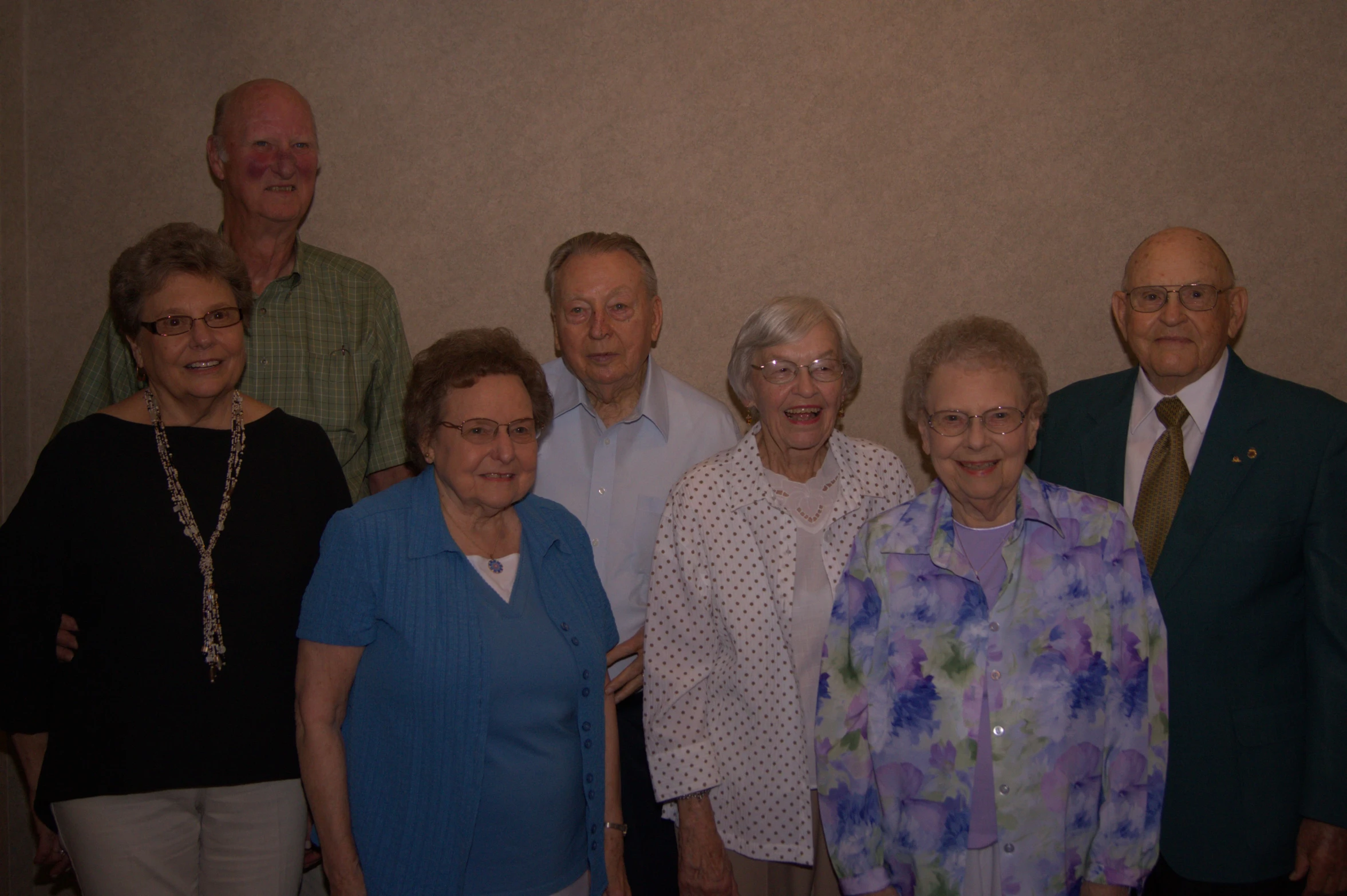 a group of older people pose for a picture