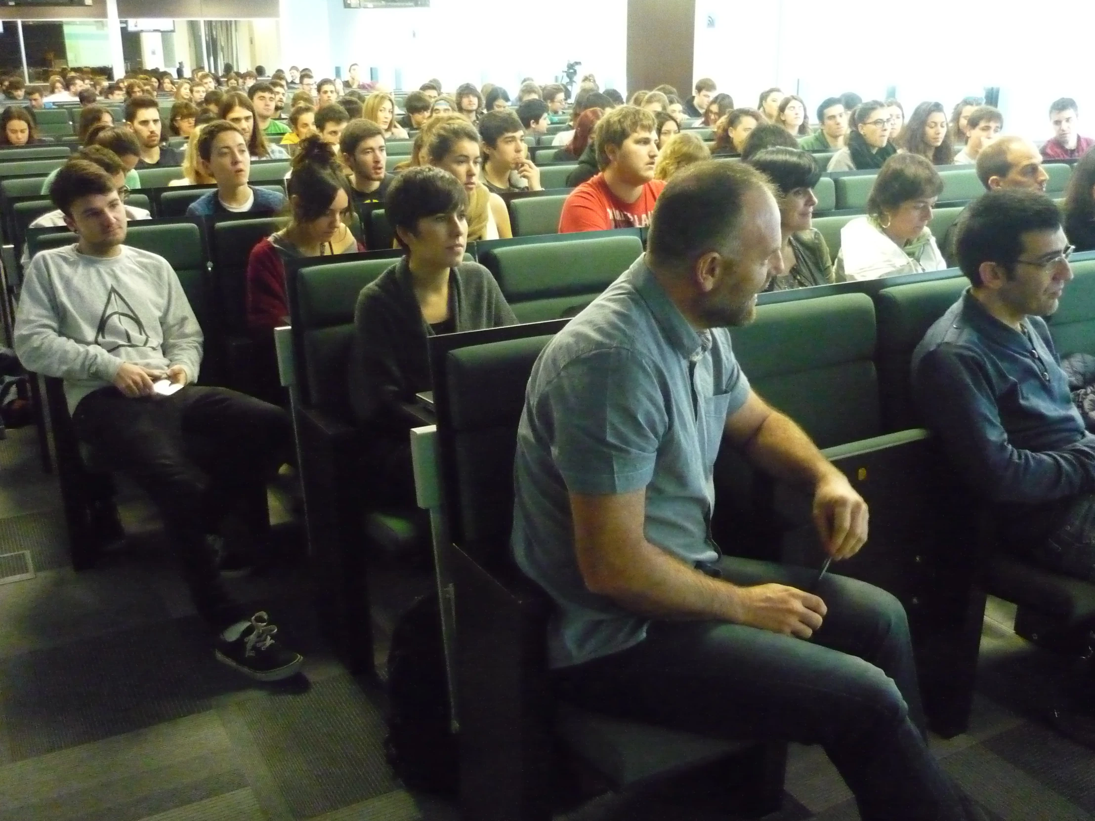 a man in the audience at a lecture hall